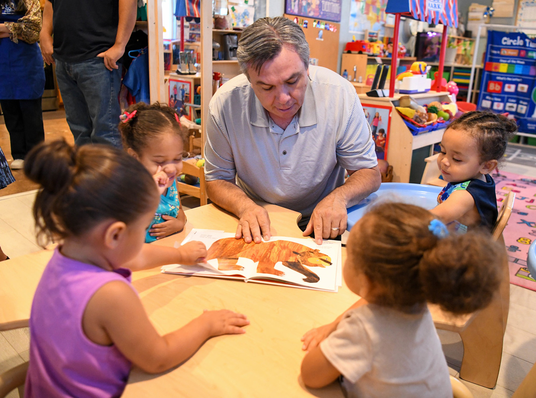 Assemblymember Juan Carrillo reading to children at a 2023 Home Provider Visit.