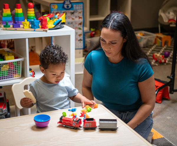 A mother and a child playing with toys.