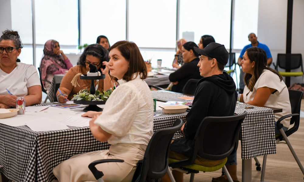 A group of parents sitting around at a table during a Parent Cafe. 